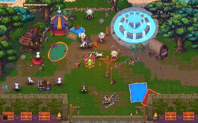 A screenshot from a 2D isometric game showing a lively medieval-style camp or festival scene with characters, a circus tent, fountain, campfire, wagon, and various animals and decorations in a forested area.