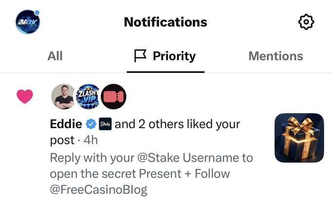 A screenshot of a social media "Notifications" page under the "Priority" tab shows that user Eddie (@Stake) and 2 others liked the poster's post 4 hours ago, with a call-to-action to reply with a @Stake username to open a secret Present and follow @FreeCasinoBlog, visually reinforced by an image of a gold gift box. This aligns with the accompanying post thanking @StakeEddie for sending Ethereum and asking viewers to share their @Stake usernames.