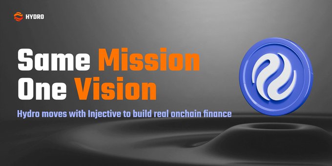 The image features a logo for a company named "Hydro" that has an injective symbol, which is a blue circle with a white line through it. The background of the image is black, making the logo stand out prominently. Below the logo, there's text that reads "Same Mission One Vision". This suggests that the company operates under a common vision or mission statement for its employees and stakeholders. The text also mentions that the company is moving with the same intensity as the injective symbol, which implies a strong commitment to their goals and objectives.