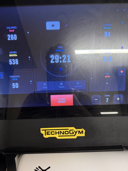 A close-up photo of a TechnoGym treadmill display showing workout stats: 260 calories, 538 moves, 94 floors, a time of 29:21, and a cadence of 50 SPM at level 7.