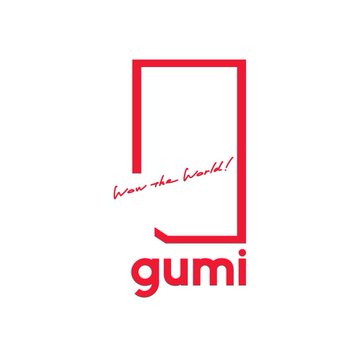 The image displays the red logo of Gumi, a Japanese game developer, featuring a stylized "g" design with the tagline "Wow the World!" above the company name "gumi." The logo visually represents the company mentioned in the post, which has launched an $18.3 million Bitcoin and altcoin fund with SBI Financial Services.