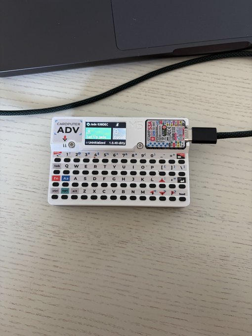 A Blockstream Jade ADV device is shown, powered on and displaying "Uninitialized 1.0.40-dirty". This device is likely being set up, as indicated by the "Set Up Jade" option visible on its screen.