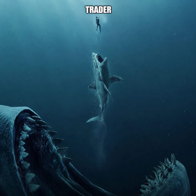 An underwater scene labeled 'TRADER' showing a tiny diver on the surface while massive sharks with open jaws lurk below in the deep.