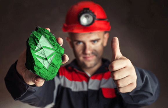 A miner wearing a red hard hat holds a glowing green crystal etched with the Ethereum logo while giving a thumbs-up.