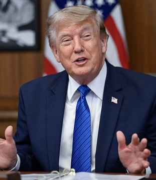 Donald Trump speaks at a podium with an American flag behind him, appearing to be mid-conversation with his hands raised expressively. The image relates to the post's mention of "$TRUMP," a meme cryptocurrency associated with the former president, which is highlighted as having generated a 16,700% return on investment in just 24 hours compared to the $LAPTOP token.