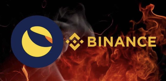The Terra (Luna) logo on the left and the Binance logo on the right are set against a backdrop of flames, likely referencing the collapse of the Terra cryptocurrency.