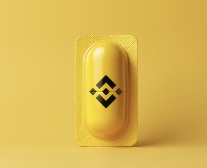 A yellow blister pack containing a single yellow pill with a black geometric symbol on it, set against a matching yellow background.