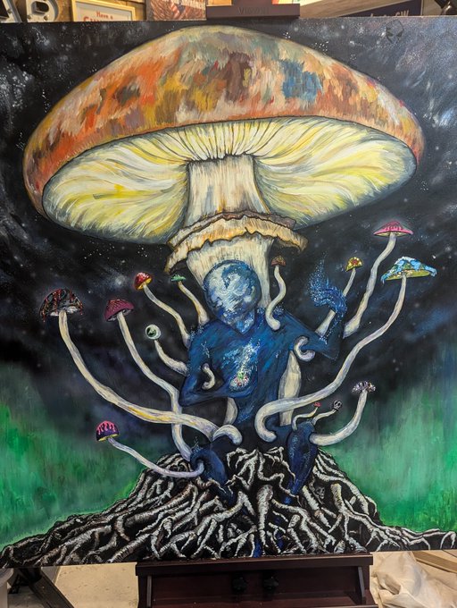 A painted canvas shows a surreal scene with a giant orange and white mushroom, a blue humanoid figure surrounded by smaller mushrooms, and a forest at the base against a starry night sky.