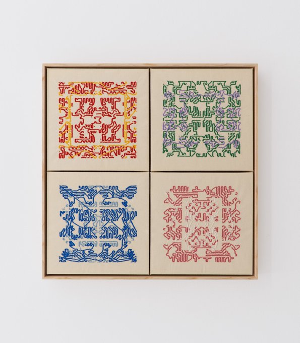 A wooden frame displaying four cream-colored fabric panels with colorful symmetrical maze-like tangle patterns in red/orange, green/purple, blue, and red.