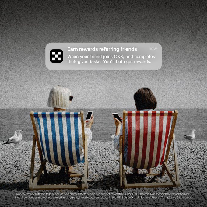 Two friends sit in striped beach chairs (one blue, one red) on a pebbled shore, each looking at their phone, as an OKX notification overlay reads "Earn rewards referring friends — now. When your friend joins OKX, and completes their given tasks. You'll both get rewards." This visual ties directly to the post's call to action, illustrating the referral program where users can earn together by inviting friends through Home > Referrals > Invite Friends.