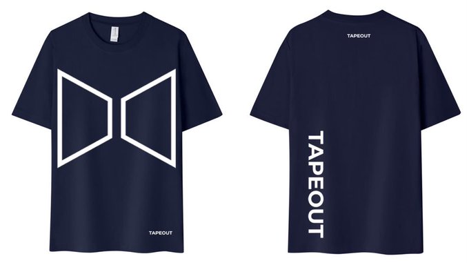 The image shows the front and back views of a navy blue T-shirt featuring a large white geometric "M"-shaped logo on the front, with "TAPEOUT" printed vertically on the back and as small text near the collar and hem. This promotional shirt is being offered for free to TapeOut developers who sign up, as referenced in the accompanying post.