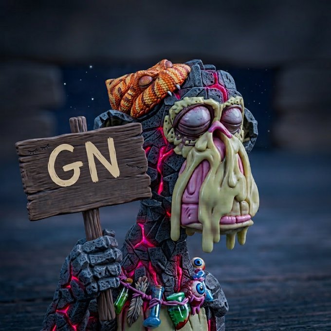 A detailed sculpture of a grotesque, melting creature with a snake on its head holds a wooden sign reading 'GN'.