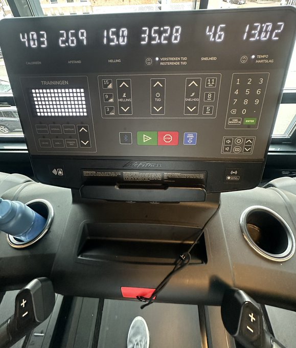 The console of a Life Fitness treadmill displays workout metrics including a calorie burn of 403, distance of 2.64, incline of 15.0, time of 35:28, speed of 4.6, and heart rate of 130.