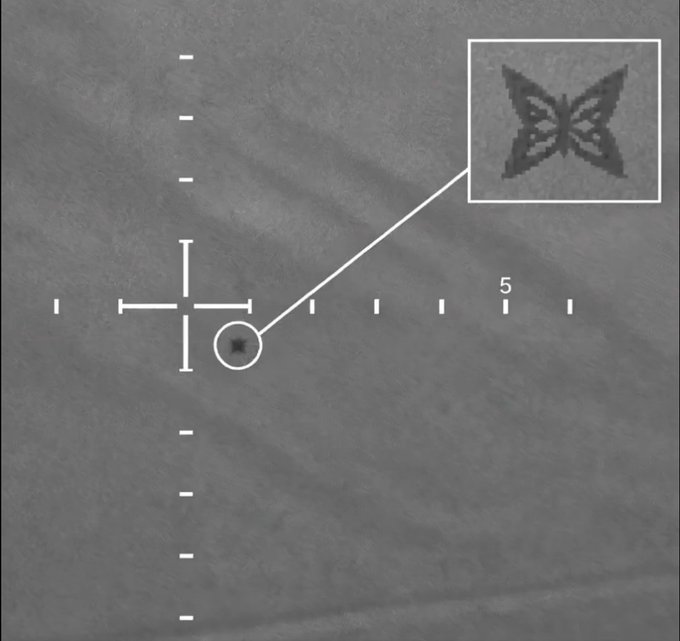 The image shows a gray background with a black and white butterfly design, which is located near the top right corner of the frame. The butterfly has a diamond shape and is surrounded by a line of small dots. In the bottom left corner of the image, there's a text box that reads "Industrial optimization needs more oomph than usual cloud setups. That'S why @quipnetwork catches my eye. They're blending classical and quantum computing for heavy-duty tasks". The butterfly design is placed in the top right corner of the image, while the text box is positioned near it.