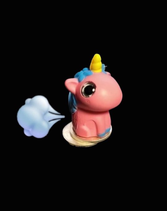 A small pink toy unicorn figurine with a yellow horn, blue mane, large eyes, and a puff of blue 'wind' coming from its rear, set against a black background.