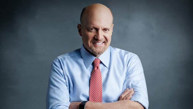 A confident, smiling bald man with a goatee, wearing a light blue dress shirt and red patterned tie, stands with arms crossed against a dark gray background. The image corresponds to the accompanying post featuring Jim Cramer, known for his financial commentary on market rallies and investment strategies.