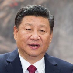 Chinese President Xi Jinping calls for "positive" competition with the U.S. and peaceful coexistence, as seen in this portrait, amidst ongoing tensions that could impact global markets.
