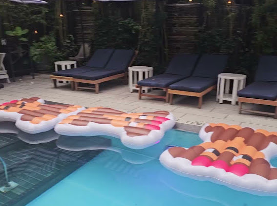 Large ice cream-shaped pool floats floating in a swimming pool at a resort.