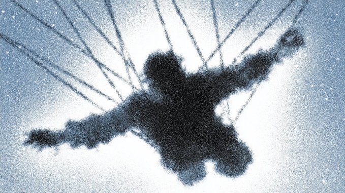 An artistic silhouette of a parachute jumper viewed from below against a bright, snowy or cloudy sky background.