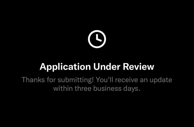 A dark screen displays a clock icon and the message 'Application Under Review,' noting 'Thanks for submitting! You'll receive an update within three business days.'