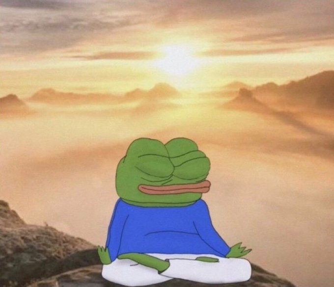 An animated image of Pepe the Frog meditating cross-legged against a serene sunset backdrop with mountains and clouds.