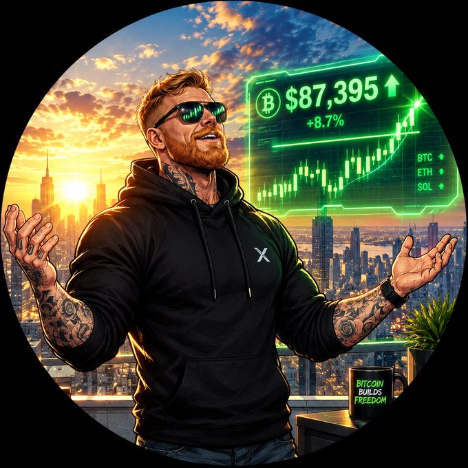 A stylized circular illustration of a bearded man wearing an X-branded hoodie and sunglasses with Bitcoin logos, standing before a city skyline with a holographic chart showing BTC at $87,395 (+8.7%) and a mug reading 'BITCOIN BUILDS FREEDOM'.