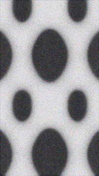 A grainy, close-up texture of a perforated metal sheet with oval-shaped holes arranged in a staggered pattern.