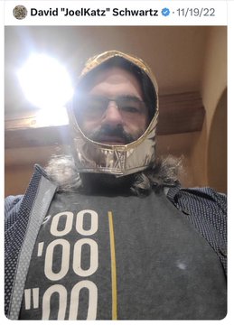 The image shows a selfie of a bearded man wearing a knight's helmet and a dark shirt with repeating "00" and "'''" patterns, with the social media handle "David 'JoelKatz' Schwartz - 11/19/22" displayed at the top. The post is tagged #XRP, connecting the image to David Schwartz, the CTO of Ripple, likely referencing a medieval or warrior-themed XRP/XRP Army community post.