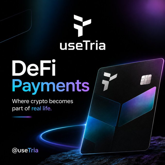 The image features a black credit card with a logo for UseTria, which is an online payment platform. The credit card has a unique design that resembles a Rubik's cube, adding a creative touch to its appearance. The text on the image reads "Where crypto becomes part of real life", suggesting that users can earn through everyday activities like spending at local businesses or participating in community events. This encourages users to engage with the platform and contribute to the ecosystem by using their credit card for purchases.