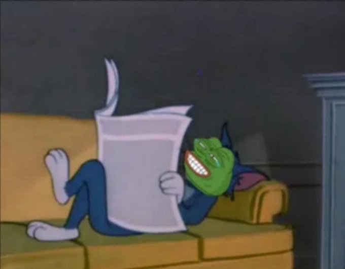 A cartoon scene of a character with a green grinning mask lying on a couch reading a newspaper.
