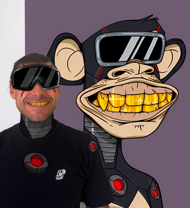 A man wearing large futuristic goggles poses next to a cartoon monkey character also wearing tech goggles and gold grills.
