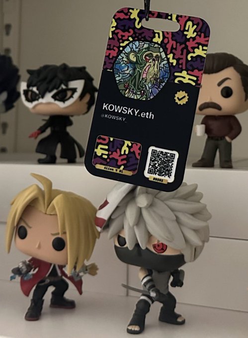 A "@KOWSKY.eth" Flextag with a colorful abstract design and a QR code hangs in front of a display of Funko Pop figures (including what appears to be Edward Elric from Fullmetal Alchemist and other characters), promoting the @alien_inks x @flextag x @KOWSKY_ x @NY_Comic_Con collaboration.