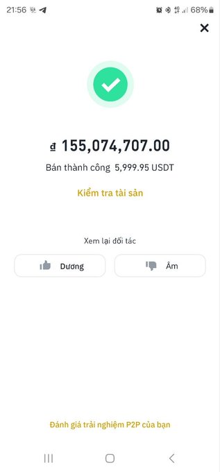 A screenshot showing a successful P2P crypto transaction confirmation of ₫155,074,707.00 from selling 5,999.95 USDT, with options to review assets, check the trading partner, and leave feedback (thumbs up/down). The image directly supports the post's theme of cashing out crypto profits, illustrating the author's successful monthly withdrawal in Vietnamese Dong (VND) before waiting for the upcoming Vietnam exchange launch.