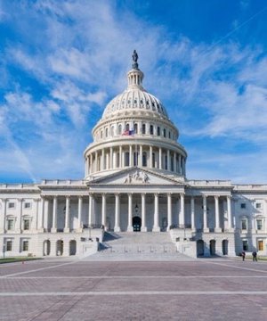 The image features a large, white building with columns and a dome, which appears to be the U.S. Capitol Building in Washington D.C. The sky above the building has some clouds, suggesting that the photo was taken during an overcast day or at a time when the sun is partially obscured by the cloud cover. The caption provided seems unrelated to the image itself and could be a random piece of information or a distraction from the main subject matter.