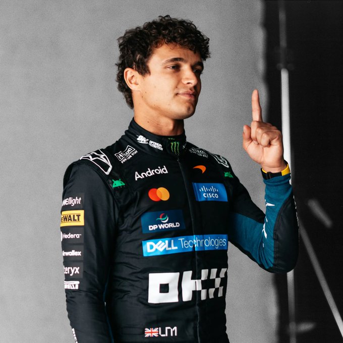 Lando Norris, wearing his McLaren team kit with visible sponsor logos including Android, Cisco, DP World, Dell Technologies, Hilton, and Mastercard, points upward in celebration after securing pole position. The "New Money Liveries" mentioned in the post are showcased on his sleek black and teal race suit, with the distinctive OKX branding prominently displayed.
