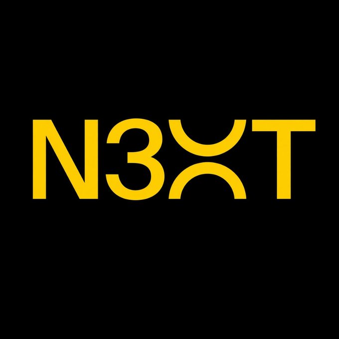 The image displays the logo for "N3XT," featuring bold yellow text on a black background, with the "X" stylized as a digital token symbol. The logo visually represents the new Wyoming-regulated bank founded by former Signature Bank Chair Scott Shay, which is being launched to offer instant, fee-free overseas payments via a digital token.