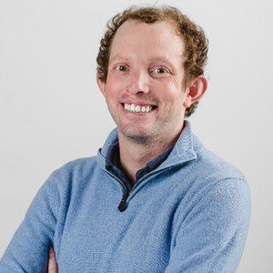 The image shows a man wearing a blue sweater with his arms crossed against a white background. The photo captures him looking directly at the camera, giving off a serious expression. The caption provided below the image reads "BREAKING: Tragic news from the RWA space Nathan Allman, founder and CEO of Ondo Finance has passed away unexpectedly." This statement is relevant to the image as it provides context about the man's passing and his connection to the RWA space.