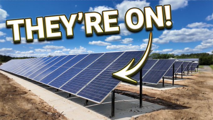 Rows of solar panels are installed in a field under a bright blue sky with the bold text "THEY'RE ON!" and a yellow arrow pointing to the array, visually emphasizing the activation of a new solar installation that aligns with the post's message about embracing solar energy for the future.