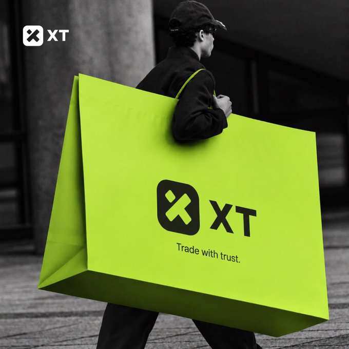A man in a black cap carries an oversized bright green shopping bag featuring the "XT" logo and the tagline "Trade with trust," playing into the post's humorous "crypto shopping spree" theme. The image ties to the caption by exaggerating the concept of crypto trading excitement, with the bag symbolically overflowing with purchases—much like the idea of the market being too good to resist.