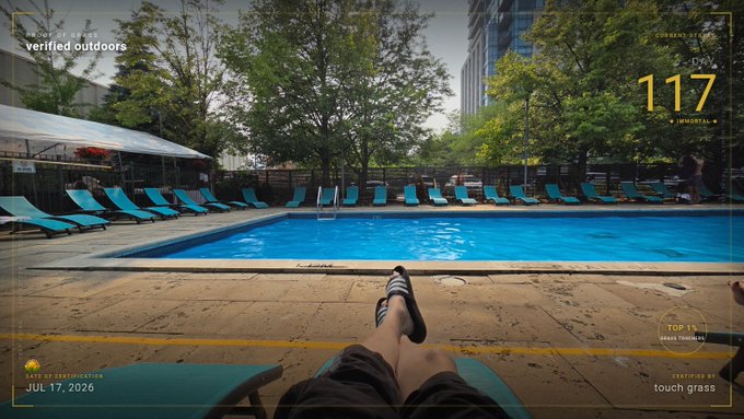 A first-person view photo of someone resting their feet by a blue swimming pool surrounded by teal lounge chairs and trees, with augmented reality overlay text including 'verified outdoors,' '117 DAYS,' 'JUL 17, 2026,' and 'touch grass.'