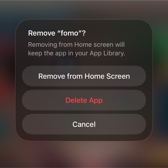 The image shows an iOS confirmation dialog asking "Remove 'fomo'?" with options to "Remove from Home Screen," "Delete App" (in red), or "Cancel." The post appears to humorously suggest that ditching the "fomo" (fear of missing out) app represents a bold pivot, with the looming red "Delete App" button symbolizing a decisive, liberating choice.