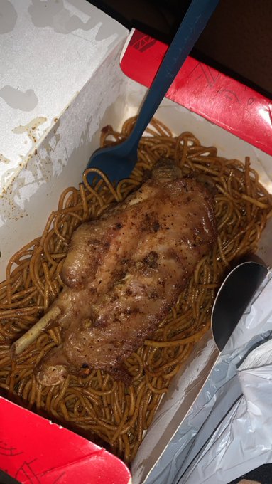 A takeout box contains noodles topped with a braised meat shank, with a blue plastic fork resting in the dish—fitting the caption "Life of a web3 student that barely cooks" as it shows a quick delivery meal instead of home-cooked food.
