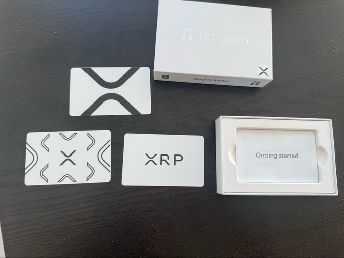 Tangem's first-ever XRP-themed hardware wallet, featuring the XRP logo and Tangem branding, alongside its packaging and a "Getting started" guide, shown to promote a limited 20% discount for the community.
