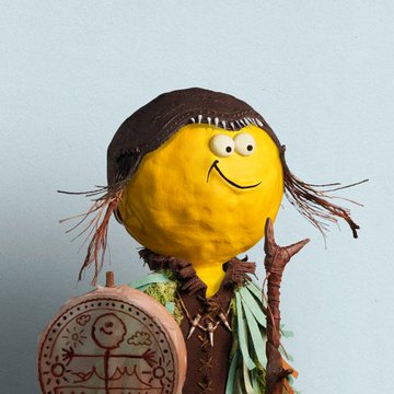 The image features a yellow cartoon face with brown hair, wearing a hat and holding a stick or a drumstick. The caption below the image reads "NFTs are awesome, especially @D3lMundos". This suggests that the image is related to NFTs (Non-Fungible Tokens) and possibly has some connection to the artist D3lMundos.