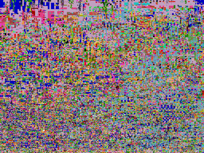 A chaotic, glitch-art style image composed entirely of densely packed, brightly colored pixels in a random, static-like pattern.