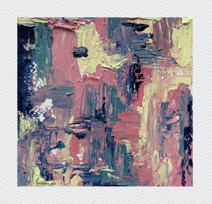 An abstract painting featuring thick, textured brushstrokes in pink, yellow, green, and dark blue tones, mounted on a white textured wall with a signature at the bottom.