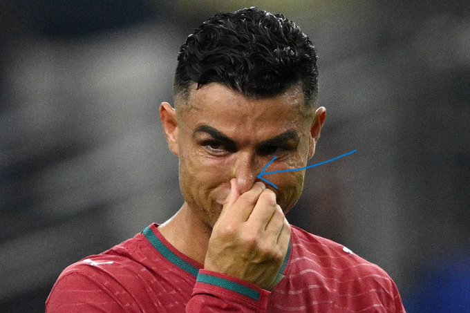 Cristiano Ronaldo is shown wiping his eye with his fingers, a gesture at the center of a heated Polymarket debate over whether he was crying or simply wiping away sweat during a match. The image directly fuels speculation tied to a betting market on "will-ron..." (likely "will-Ronaldo-cry") that could pay out over $5,000 if it resolves "yes."