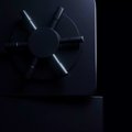 A shadowy safe with a combination dial sits in dim lighting, symbolizing hidden value and locked-in potential. The image visually reinforces the post's warning about impending price repricing and billions in $XRP and $FLR being "stored" or secured, ready for a market shift.