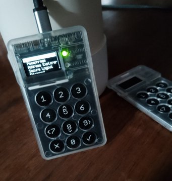 A Coldcard hardware wallet displays "WARNING: Enter passphrase" on its screen alongside a green status light, with the numeric keypad and "DIANA MK4" branding visible through its clear case. The image visually reinforces the post's narrative about safely migrating funds off the affected Coldcard setup using dice rolls and a strong passphrase, capturing the pivotal moment of unlocking the device before broadcasting the transaction.