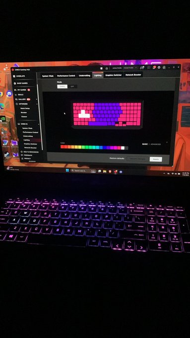 A laptop with RGB backlit keys displaying the SteelSeries GG software interface, showing keyboard lighting customization settings with a pink and blue color preview.